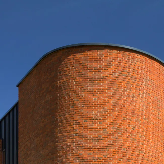Aluminium curved coping fitted to roof line of award winning home.